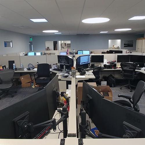 Engineering desks with multiple monitors inside the IQC office